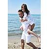 happy young couple have fun and romantic moments on beach at summer season and representing happynes and travel concept