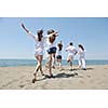 happy people group have fun  run and jump  on beach beautiful sand  beach