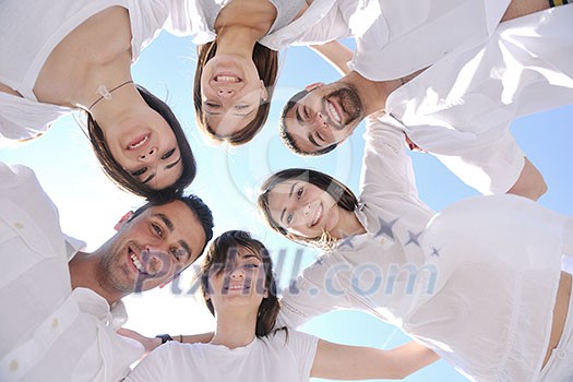 Group of happy young people in circle at beach have fun and smile Group of happy young people in circle at beach have fun and smile