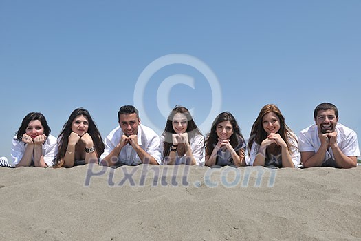 Group of happy young people in circle at beach have fun Group of happy young people in circle at beach have fun