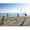 young people group have fun and play beach volleyball at sunny summer day