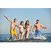 happy people group have fun  run and jump  on beach beautiful sand  beach