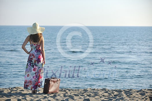 woman with suitcase travel bag on the beach representing exotic and luxury escape and freedom woman with suitcase travel bag on the beach representing exotic and luxury escape and freedom