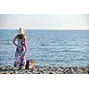 woman with suitcase travel bag  on the beach  representing exotic and luxury escape and freedom