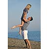 happy young couple have romantic time on beach at sunset