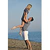 happy young couple have romantic time on beach at sunset