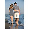 happy young couple have romantic time on beach at sunset