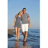 happy young couple have romantic time on beach at sunset