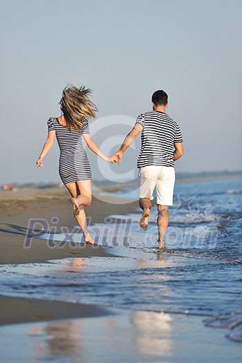happy young couple have romantic time on beach at sunset happy young couple have romantic time on beach at sunset