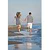 happy young couple have romantic time on beach at sunset