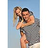 happy young couple have romantic time on beach at sunset