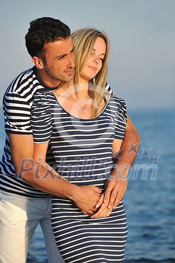 happy young couple have romantic time on beach at sunset happy young couple have romantic time on beach at sunset