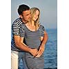 happy young couple have romantic time on beach at sunset