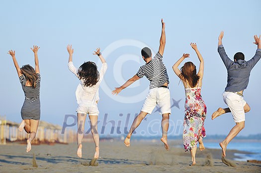 happy young people group have fun run and jump on beach beautiful sand beach happy young people group have fun run and jump on beach beautiful sand beach