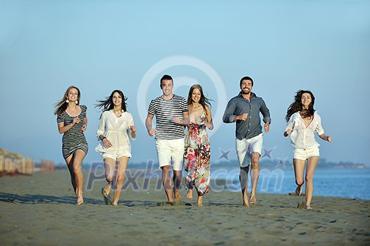 happy young people group have fun run and jump on beach beautiful sand beach happy young people group have fun run and jump on beach beautiful sand beach