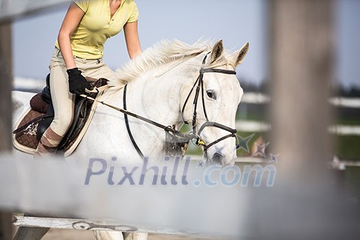 Young woman show jumping with horse Young woman show jumping with horse