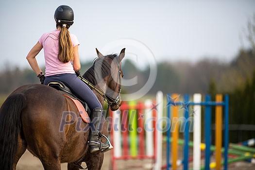 Young woman show jumping with horse Young woman show jumping with horse