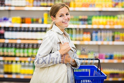 Pretty, young woman buying groceries in a supermarket/mall/gr ocery store (color toned image; shallow DOF) Pretty, young woman buying groceries in a supermarket/mall/gr ocery store (color toned image; shallow DOF)