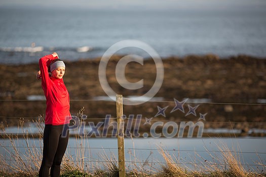 Young woman on her evening jog along the seacoast Young woman on her evening jog along the seacoast