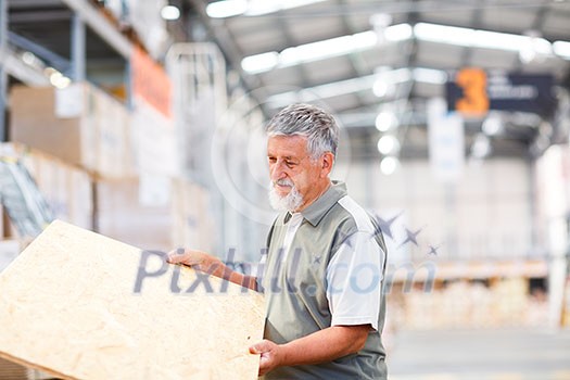 Man buying construction wood in a DIY store for his DIY home re-modeling project Man buying construction wood in a DIY store for his DIY home re-modeling project