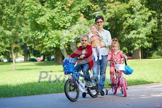 portrait of happy young family, mother and kids have fun in park portrait of happy young family, mother and kids have fun in park