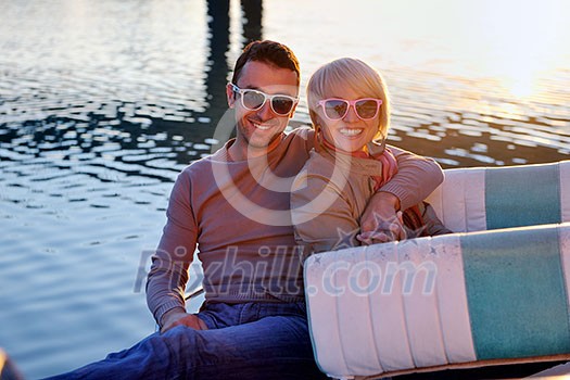 happy young couple in love have romantic time at summer sunset at ship boat while representing urban and countryside fashin lifestyle happy young couple in love have romantic time at summer sunset at ship boat while representing urban and countryside fashin lifestyle