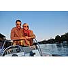 happy young couple in love  have romantic time at summer sunset   at ship boat while  representing urban and countryside fashin lifestyle