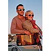 happy young couple in love  have romantic time at summer sunset   at ship boat while  representing urban and countryside fashin lifestyle