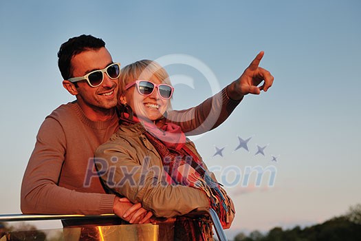 happy young couple in love have romantic time at summer sunset at ship boat while representing urban and countryside fashin lifestyle happy young couple in love have romantic time at summer sunset at ship boat while representing urban and countryside fashin lifestyle