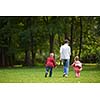 happy family playing together outdoor  in park mother with kids  running on grass