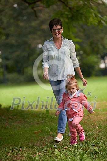 happy family playing together outdoor in park mother with kids running on grass happy family playing together outdoor in park mother with kids running on grass