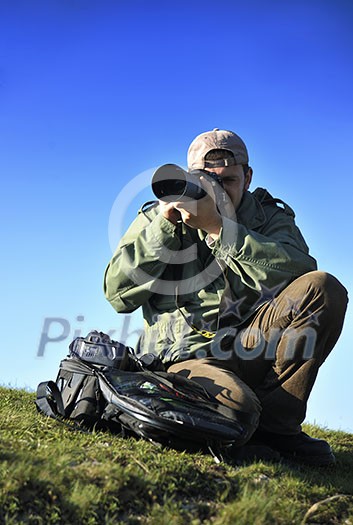 Nature photographer with digital camera on top of the mountain Nature photographer with digital camera on top of the mountain