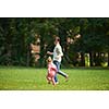 happy family playing together outdoor  in park mother with kids  running on grass
