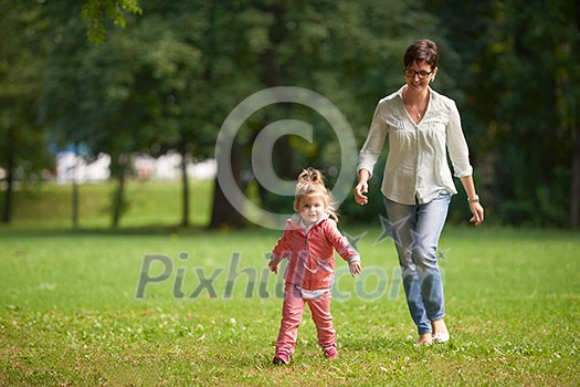 happy family playing together outdoor in park mother with kids running on grass happy family playing together outdoor in park mother with kids running on grass