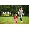 happy family playing together outdoor  in park mother with kids  running on grass