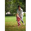 happy family playing together outdoor  in park mother with kids  running on grass
