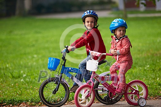 happy kids in park, boy and girl in nature with bicycle have fun happy kids in park, boy and girl in nature with bicycle have fun