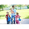 portrait of happy young family,  mother and  kids have fun in park