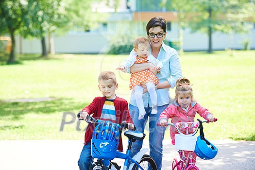 portrait of happy young family, mother and kids have fun in park portrait of happy young family, mother and kids have fun in park