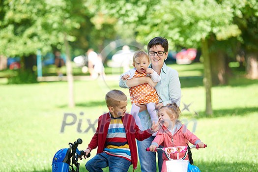 portrait of happy young family, mother and kids have fun in park portrait of happy young family, mother and kids have fun in park