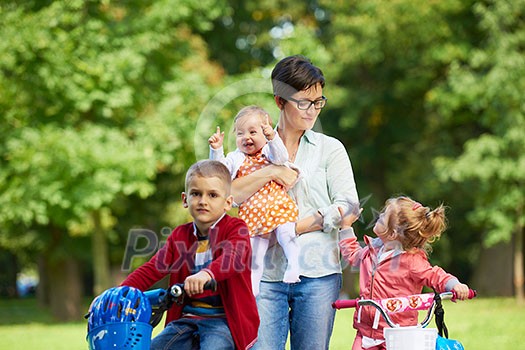 portrait of happy young family, mother and kids have fun in park portrait of happy young family, mother and kids have fun in park