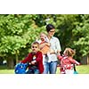 portrait of happy young family,  mother and  kids have fun in park