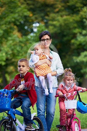 portrait of happy young family, mother and kids have fun in park portrait of happy young family, mother and kids have fun in park