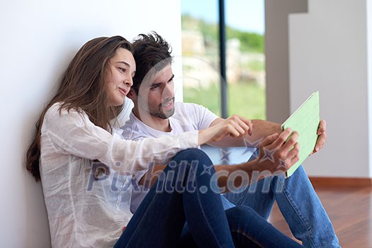 romantic relaxed young couple at modern home using tablet computer romantic relaxed young couple at modern home using tablet computer