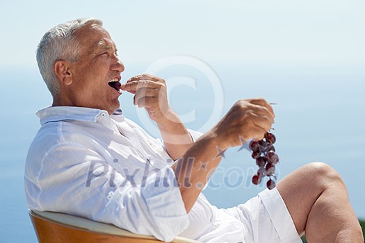 Portrait of senior man sitting outside Portrait of senior man sitting outside