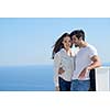 happy young romantic couple have fun relax smile at modern home outdoor terace balcony terace