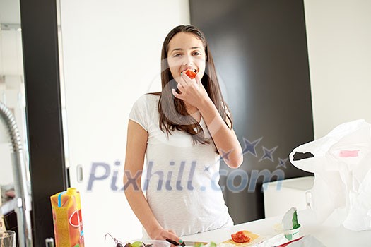 Young Woman Cooking in the kitchen. Healthy Food - Vegetable Salad. Diet. Dieting Concept. Healthy Lifestyle. Cooking At Home. Prepare Food Young Woman Cooking in the kitchen. Healthy Food - Vegetable Salad. Diet. Dieting Concept. Healthy Lifestyle. Cooking At Home. Prepare Food