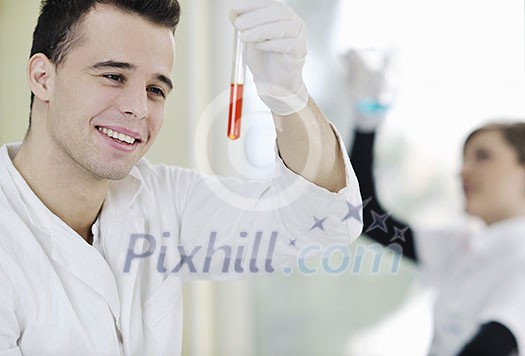 young students couple making test in bright labaratory young students couple making test in bright labaratory