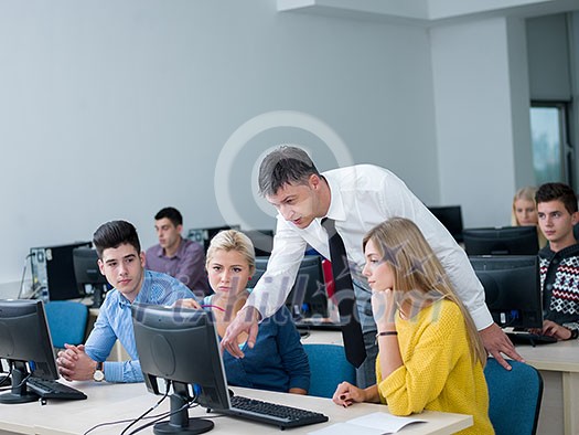 group of students with teacher in computer lab classrom learrning lessons, get help and support group of students with teacher in computer lab classrom learrning lessons, get help and support