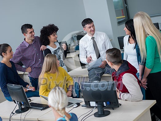 group of students with teacher in computer lab classrom learrning lessons, get help and support group of students with teacher in computer lab classrom learrning lessons, get help and support